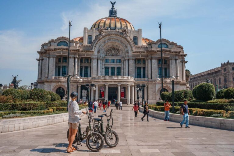 Author Mal cycling around Palacio de Bellas Artes - one of the best things to do in Mexico City.